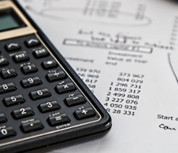 black-calculator-near-ballpoint-pen-on-white-printed-paper-53621.jpg